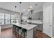 Modern kitchen features gray cabinets, stainless steel appliances, and a white quartz island with seating at 8427 Modiano St, Orlando, FL 32827