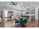 Stylish living area with open kitchen, hardwood floors and a sleek gray kitchen island with barstool seating at 8427 Modiano St, Orlando, FL 32827