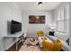 Bright living room featuring stylish decor, a work space, and comfortable seating arrangements at 8427 Modiano St, Orlando, FL 32827