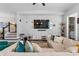 Spacious living room features a large sectional sofa, modern decor, and a large entertainment center at 8427 Modiano St, Orlando, FL 32827