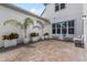 Private outdoor patio features low-maintenance landscaping with mature palms in a stylish setting at 8427 Modiano St, Orlando, FL 32827