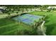 Aerial view of community tennis courts surrounded by well-manicured landscaping and green space at 8427 Modiano St, Orlando, FL 32827