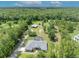 Aerial view of the home with a pool surrounded by lush landscaping and trees at 2508 Fawn Run, Oviedo, FL 32765