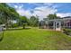 Spacious, fenced-in backyard with a view of the screened-in pool and the barn at 2508 Fawn Run, Oviedo, FL 32765