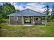 Exterior view of the barn with multiple stalls, paddocks, and grassy surroundings at 2508 Fawn Run, Oviedo, FL 32765