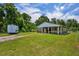 Exterior of a horse barn on a lush green lawn with a trailer visible on the property at 2508 Fawn Run, Oviedo, FL 32765