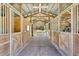 Interior view of the barn featuring wooden stalls and a metal roof at 2508 Fawn Run, Oviedo, FL 32765