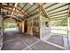 Inside the barn, showcasing well-maintained wooden stalls with metal roofing at 2508 Fawn Run, Oviedo, FL 32765