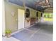 Barn interior featuring stalls, wood doors and a decorative heart and potted plant at 2508 Fawn Run, Oviedo, FL 32765