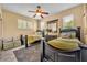 Bedroom with two twin beds, side tables, lamps, a ceiling fan, and natural lighting at 2508 Fawn Run, Oviedo, FL 32765