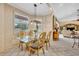 Bright breakfast nook featuring modern light fixture and views into the living room at 2508 Fawn Run, Oviedo, FL 32765