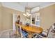 Formal dining room with wood table, chairs, chandelier, and open access to other rooms at 2508 Fawn Run, Oviedo, FL 32765