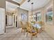 Breakfast nook with unique light fixture and windows, open to the kitchen at 2508 Fawn Run, Oviedo, FL 32765