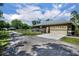 Side view of home with garage, fenced yard and the horse barn in background at 2508 Fawn Run, Oviedo, FL 32765