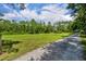 Spacious, grass-covered field with horse jumps is surrounded by a lush tree line at 2508 Fawn Run, Oviedo, FL 32765