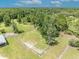 Aerial view of a horse pen with a surrounding wooden fence and lush landscaping at 2508 Fawn Run, Oviedo, FL 32765