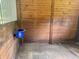 View of a horse stall with wooden walls and a blue water bucket at 2508 Fawn Run, Oviedo, FL 32765