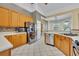 Bright kitchen with stainless steel appliances, light wood cabinetry, and tile floors at 2508 Fawn Run, Oviedo, FL 32765