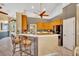 Open kitchen with breakfast bar, neutral backsplash, and stainless steel appliances at 2508 Fawn Run, Oviedo, FL 32765