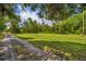 Spacious grassy field with horse jumps and a gravel drive at 2508 Fawn Run, Oviedo, FL 32765