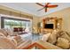 Cozy living room with comfortable seating, view to the patio, and entertainment center at 2508 Fawn Run, Oviedo, FL 32765