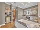 The main bath features dual sinks, granite counters, a vanity, a soaking tub, and a decorative shelving unit at 2508 Fawn Run, Oviedo, FL 32765