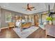 Spacious main bedroom with tray ceiling, ceiling fan, and wood flooring at 2508 Fawn Run, Oviedo, FL 32765