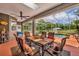 Enjoy outdoor dining on this covered patio with a ceiling fan and a view of the pool at 2508 Fawn Run, Oviedo, FL 32765