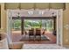 Covered outdoor patio with dining table, ceiling fans, and views of the screened-in pool at 2508 Fawn Run, Oviedo, FL 32765