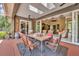 Covered outdoor patio with dining table, ceiling fans, and views of the indoor living room at 2508 Fawn Run, Oviedo, FL 32765