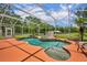 Screened-in pool with a rock waterfall feature, in-pool seating, and a spacious deck at 2508 Fawn Run, Oviedo, FL 32765