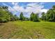 Property view showing expanse of green lawn with home and barn in the distance at 2508 Fawn Run, Oviedo, FL 32765