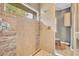 The shower features stone accents, tile walls, and a window for natural light at 2508 Fawn Run, Oviedo, FL 32765