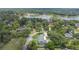 Stunning aerial view of property with pool, lush greenery, and a serene lake nearby at 102 Linda Ln, Lake Mary, FL 32746