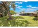 Sprawling green backyard featuring a pristine pool and a well-maintained lawn with mature trees at 102 Linda Ln, Lake Mary, FL 32746