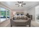 Comfortable bedroom featuring a large window, ceiling fan, and neutral decor at 102 Linda Ln, Lake Mary, FL 32746