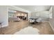 Dining room adjacent to a modern living room with wood floors and a fireplace at 102 Linda Ln, Lake Mary, FL 32746
