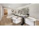 Elegant dining area with modern table setting, contemporary chairs, and wood-look tile flooring at 102 Linda Ln, Lake Mary, FL 32746