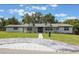 Well-maintained home with a lush green lawn, mature trees, and a contemporary driveway design at 102 Linda Ln, Lake Mary, FL 32746