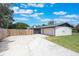 A white brick house featuring an attached two-car garage and a long driveway at 102 Linda Ln, Lake Mary, FL 32746
