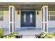 Charming front entrance featuring a blue double door, white brick, and modern light fixtures at 102 Linda Ln, Lake Mary, FL 32746