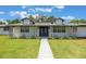 Well-maintained home exterior with a green lawn and manicured landscaping at 102 Linda Ln, Lake Mary, FL 32746