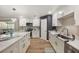 Bright kitchen features white cabinets, stainless steel appliances, and striking black and white marble countertops at 102 Linda Ln, Lake Mary, FL 32746