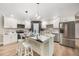 Bright kitchen with stainless steel appliances, island with seating, and white cabinetry at 102 Linda Ln, Lake Mary, FL 32746