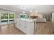 Open kitchen design with granite island, stainless appliances, and an adjacent living space at 102 Linda Ln, Lake Mary, FL 32746