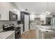 Modern kitchen features white cabinets, stainless steel appliances, and stylish black and white marble countertops at 102 Linda Ln, Lake Mary, FL 32746