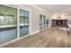 Open-concept interior with wood floors, access to a screened patio, and a living room with fireplace at 102 Linda Ln, Lake Mary, FL 32746