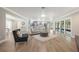 Bright and airy living room with neutral tones, wood-look tile floors, and abundant natural light at 102 Linda Ln, Lake Mary, FL 32746