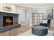 Living room featuring a cozy fireplace with black brick, wood floors, and comfortable seating at 102 Linda Ln, Lake Mary, FL 32746