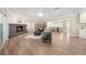 Open-concept living room with a striking fireplace, light wood floors, and open access to the dining area at 102 Linda Ln, Lake Mary, FL 32746